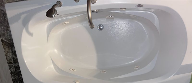Refinished white jetted drop-in tub by Blackstone Tub Refinishers Calgary
